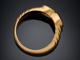 a close up of a gold ring on a black surface