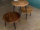 two tables that are sitting on a wooden floor