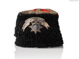 an image of a black hat with a badge on it
