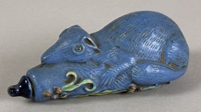a small blue animal figurine sitting on a table