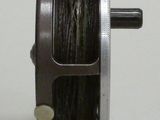 a close up of a reel on a white surface