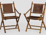 pair of wooden folding chairs with brown leather seat and back