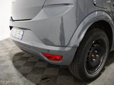 the rear end of a gray car is shown on a checkered floor
