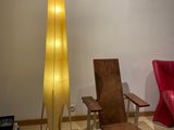 two chairs and a table in a room with a floor lamp