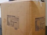 a cardboard box that is sitting on the floor next to a wall