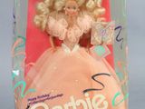 barbie doll in a box with a pink dress and gold hair