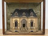 a small model of a house in a wooden case