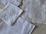 many white handkerchiefs on a table with a white table cloth