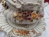 a white plate with a bowl on it and a plate with a flower on it