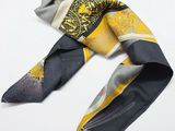 a scarf with a yellow and black design on it