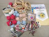 a pile of yarn, scissors, and other items on a couch
