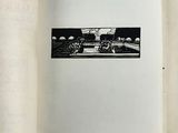 an open book with a black and white photo of a train on it