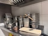 many pots and pans on the counter in the kitchen
