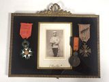 an old picture of a framed picture of a man with medals and medals