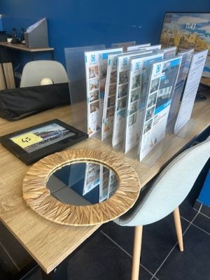 a table with magazines and a mirror on it