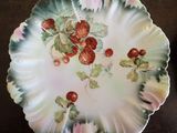 a plate with strawberries on it sitting on a table