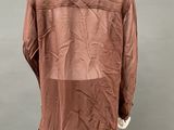 an image of a mannequin wearing a brown shirt and black pants