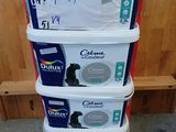 a stack of four containers with different types of paint
