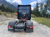 a black truck that is parked on the side of the road