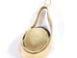 a small gold bell hanging from a gold plated pendant