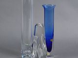 three glass vases sitting next to each other on a table