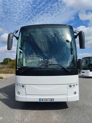 a white bus that is parked in a parking lot
