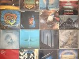 many different album covers on the wall of a room