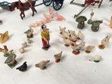 many figurines of people and animals on the table
