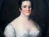 portrait of a woman in a white dress with a black background