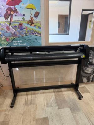 the large ploter is sitting on the floor in front of a window