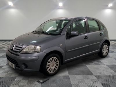 a picture of a grey car parked in a garage