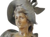 bronze statue of a woman wearing a hat and a dress