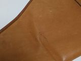 an old brown leather purse with a zipper on the inside