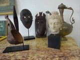 a lot of different sculptures on a table in a room