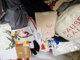 a pile of clothes and other items on a bed