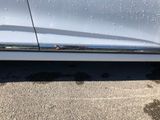 a close up of a car ' s door handle with water droplets on it
