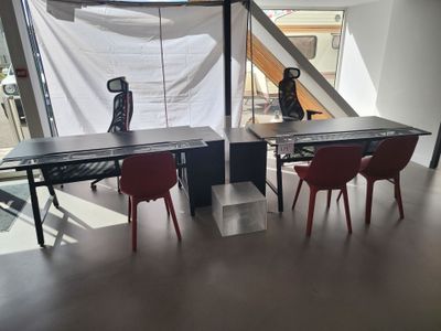 two red chairs sitting at a table in a room