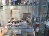 a glass case filled with silverware and silverware