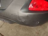 a close up of a car ' s tail light with a sticker on it