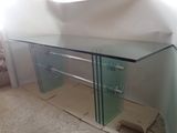 a glass table with a mirror on it in a room