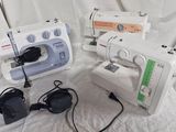 several sewing machines are lined up on a white sheet