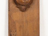 a wooden plaque with a woman ' s face on it