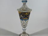 an image of a silver vase with a blue and white design on it
