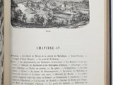 an open book with a picture of a town in it