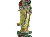 chinese figurine of a woman holding a flower in her right hand