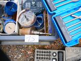 many tools in a blue case sitting on the ground