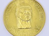 an image of a gold coin with a portrait of a man in a turban