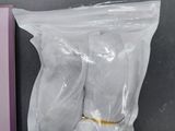 a bag of toilet paper and a pair of slippers on a table