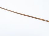 a wooden stick with a wooden handle on a white surface