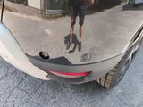 a reflection of a man walking down the street in a car